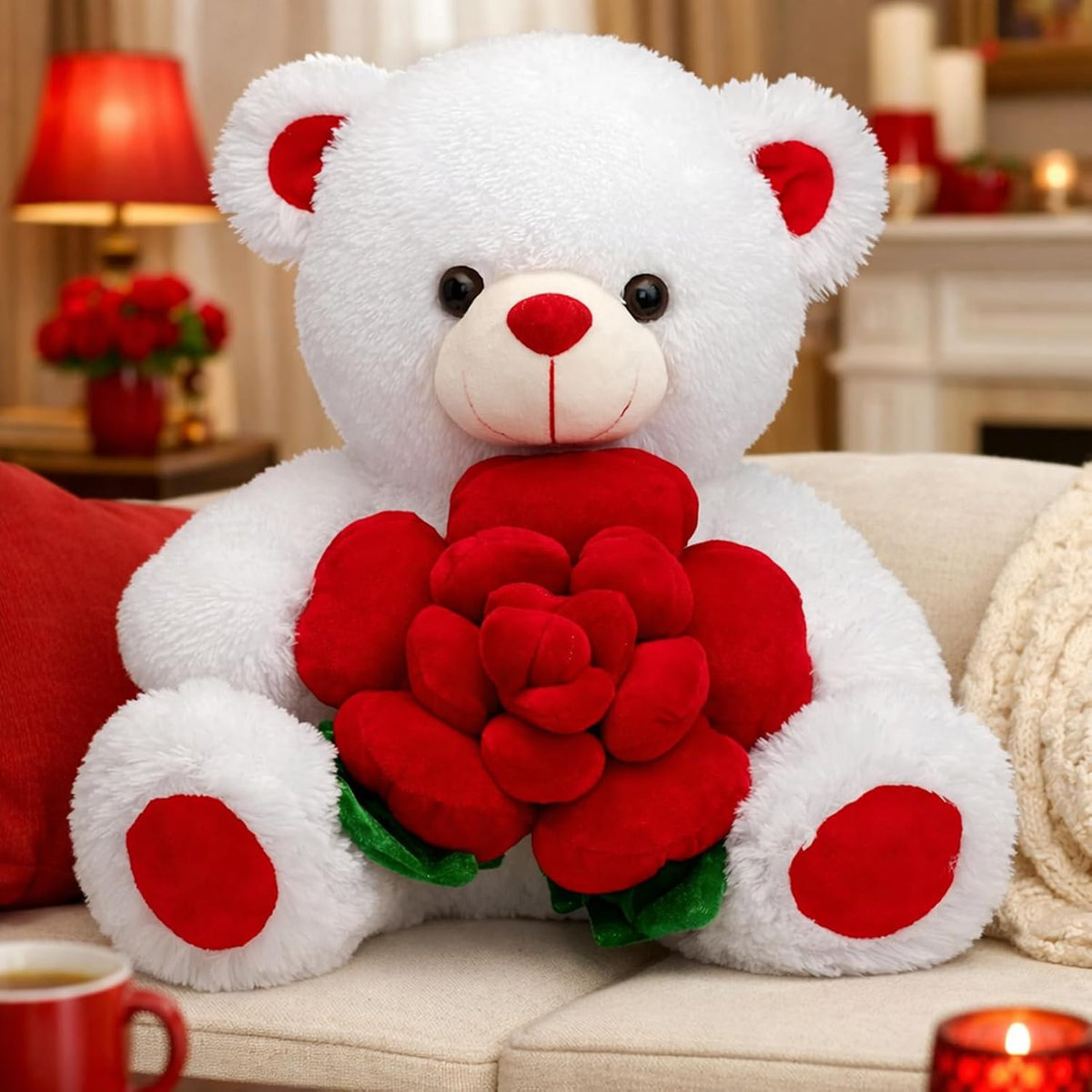 White teddy bear holding red roses on a couch with a cozy background