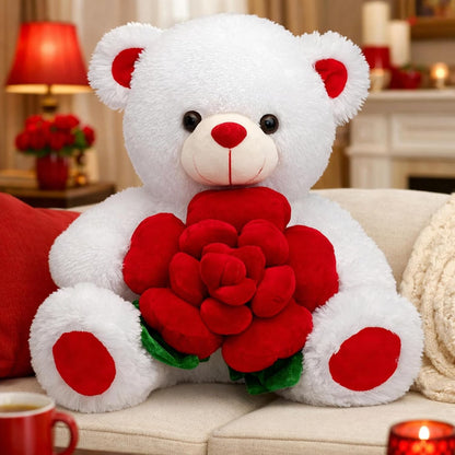 White teddy bear holding red roses on a couch with a cozy background