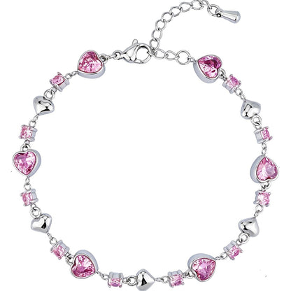 A silver-tone chain bracelet decorated with heart-shaped pink crystals and small square pink crystals, shown on a plain white background.