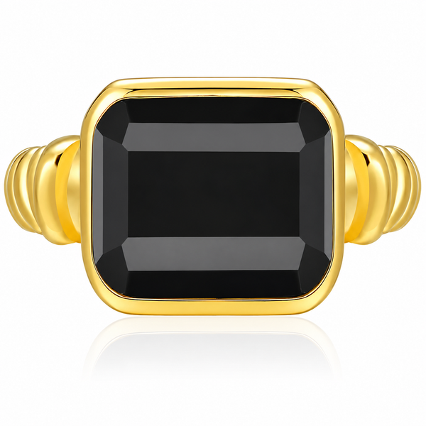 A gold ring featuring a large, faceted rectangular black gemstone in a bezel setting, with a ribbed gold band on a clean white background.
